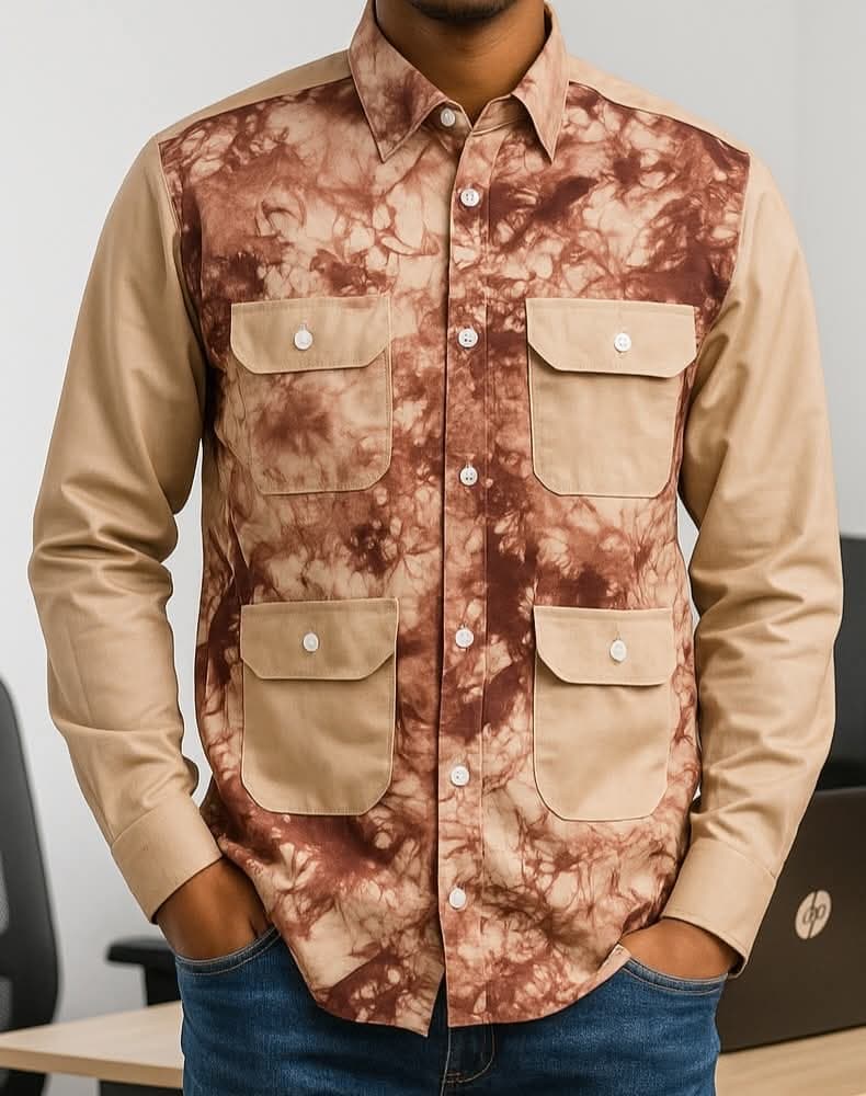 A person is wearing a button-up shirt with a brown and beige patterned design and four pockets.